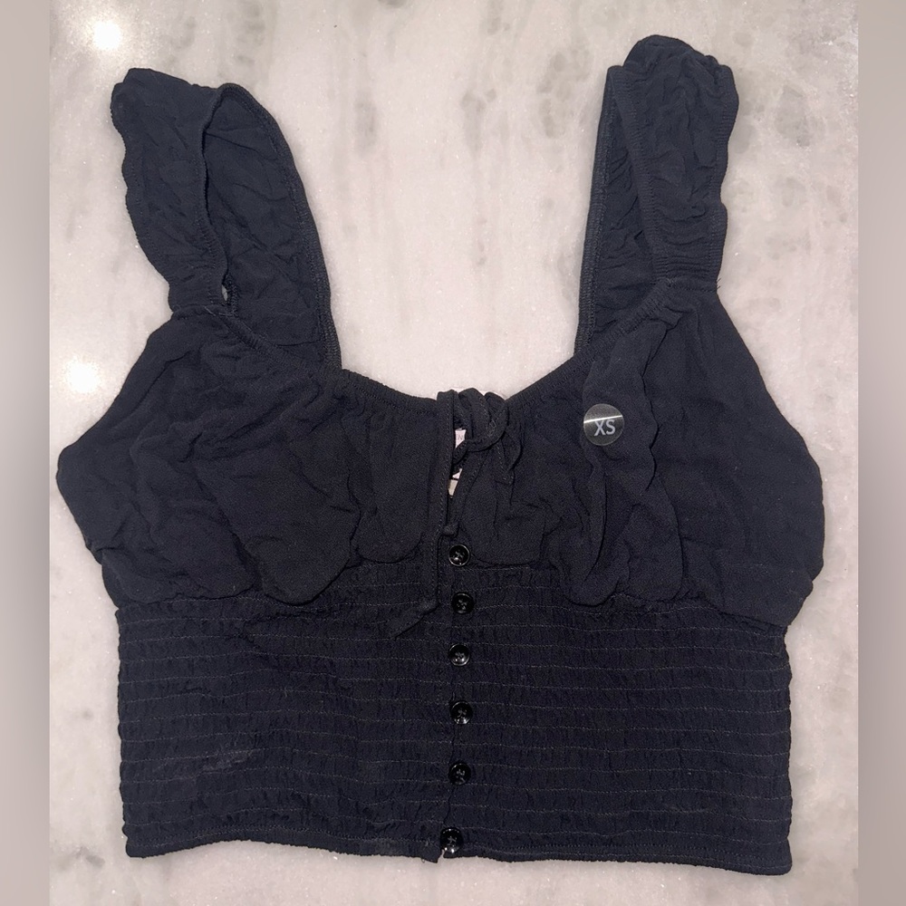 Black ruffle sleeved, tie front, LA Hearts top cam all